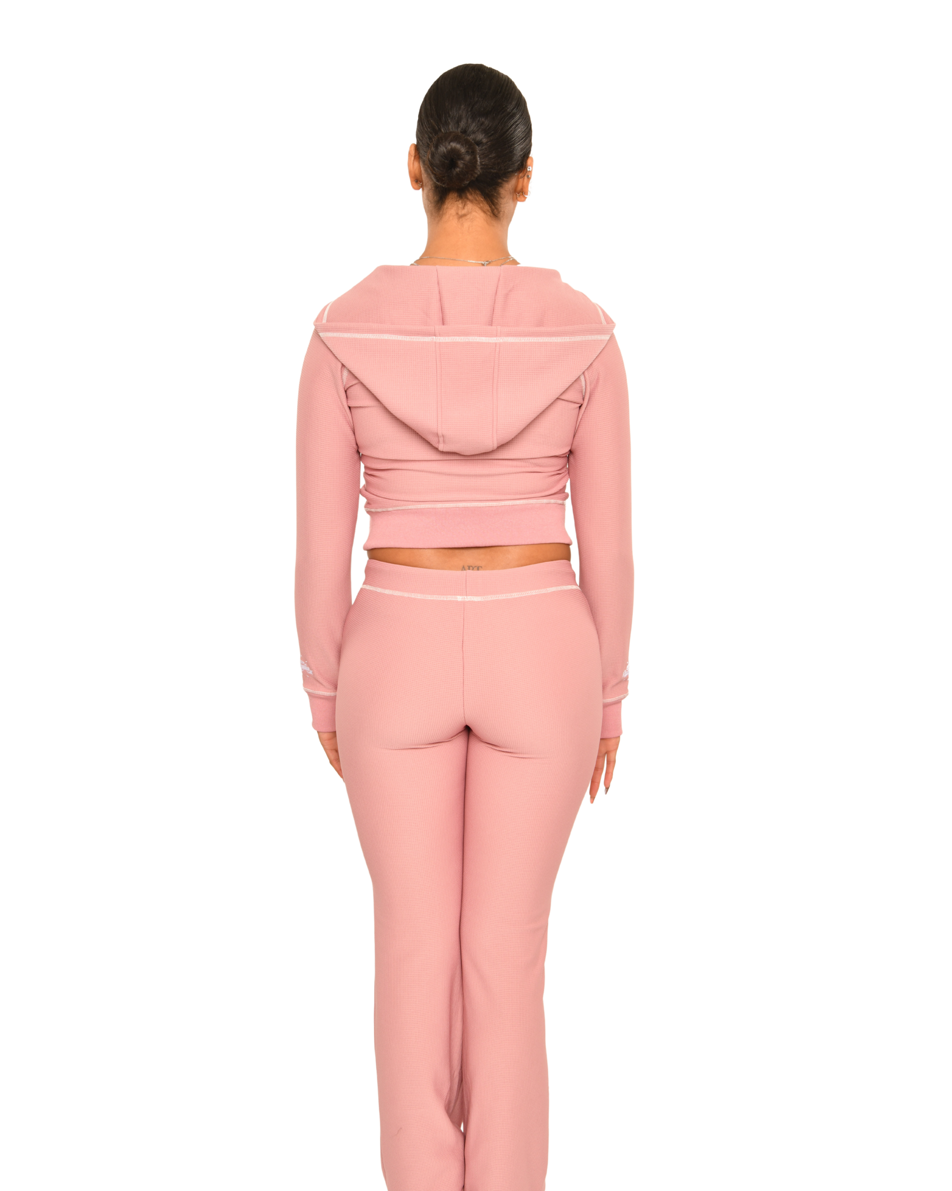 Women wearing a pink tracksuit on a white background